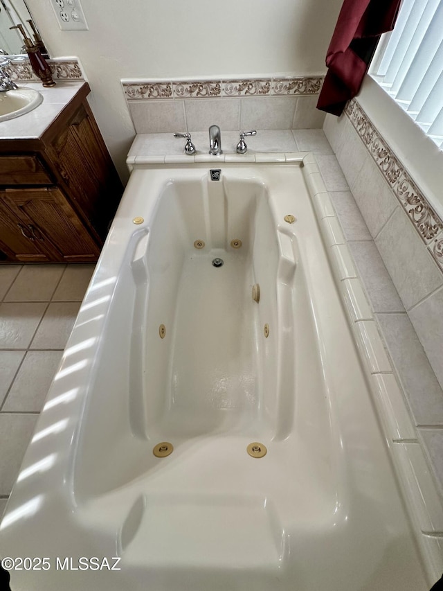 bathroom with vanity, tile patterned flooring, and a washtub