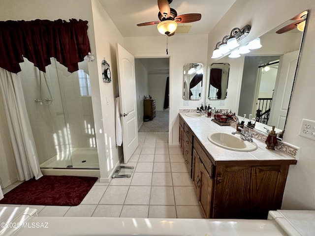 bathroom featuring tile patterned flooring, vanity, a shower with door, and ceiling fan