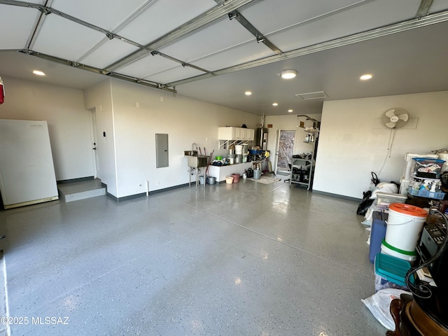 garage featuring sink and electric panel