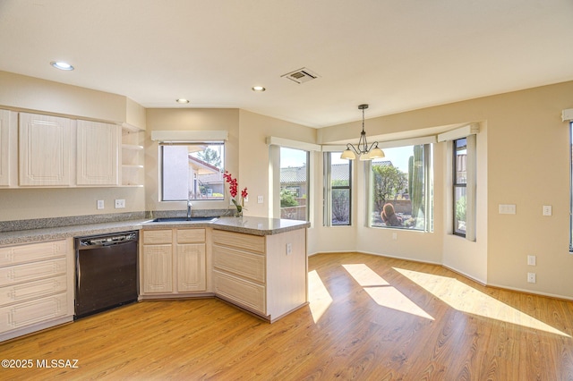 kitchen with a healthy amount of sunlight, pendant lighting, dishwasher, and light wood-type flooring