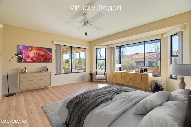 bedroom with ceiling fan and light hardwood / wood-style floors