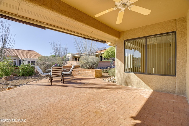 view of patio featuring ceiling fan