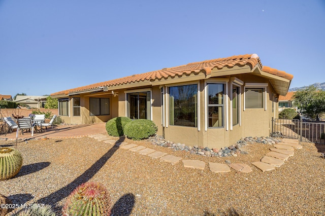 back of property with a patio