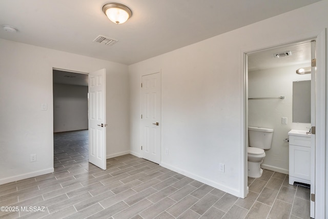 unfurnished bedroom with connected bathroom