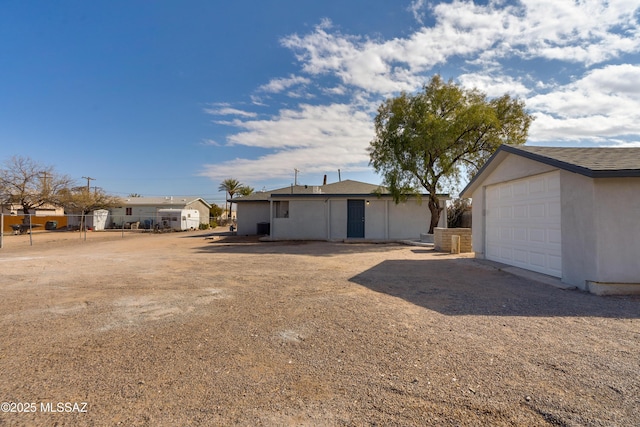 exterior space featuring an outbuilding and a garage