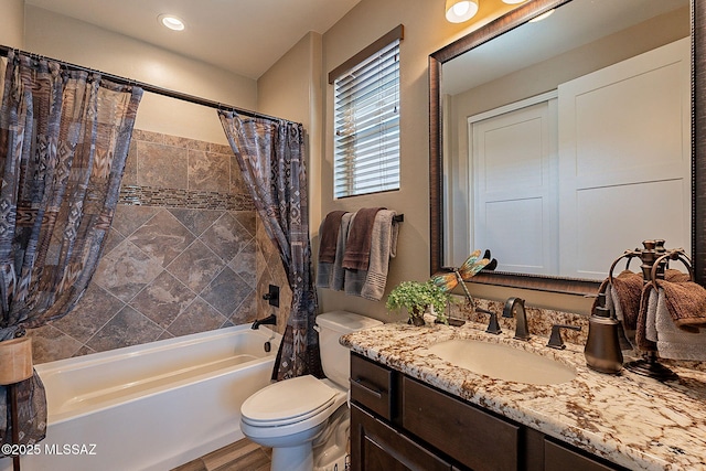 full bathroom with vanity, shower / bath combo with shower curtain, and toilet