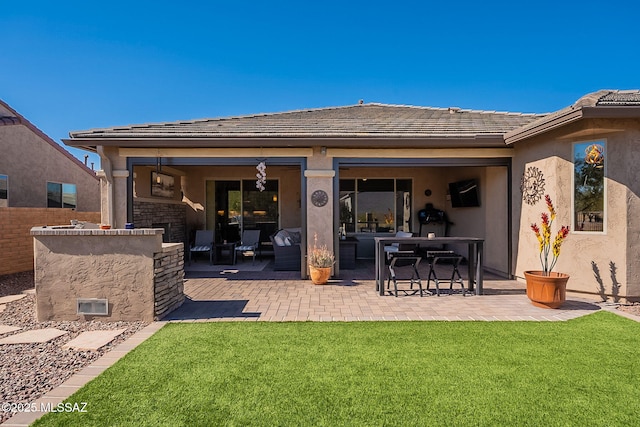 back of house with a patio and a yard