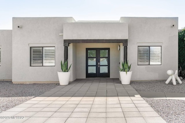 view of exterior entry featuring french doors