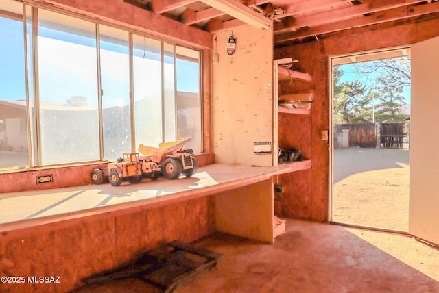 miscellaneous room featuring concrete flooring and a mountain view