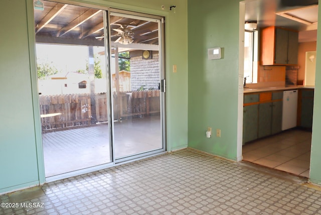 doorway with ceiling fan and sink