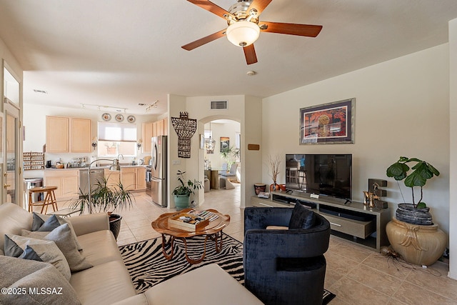 living room with light tile patterned floors and ceiling fan