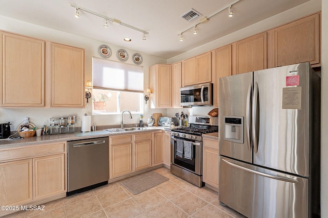 kitchen featuring sink, light brown cabinets, and appliances with stainless steel finishes