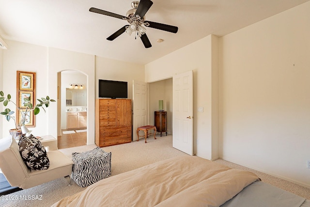 carpeted bedroom with ceiling fan and connected bathroom