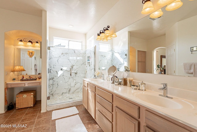 bathroom with tile patterned floors, vanity, and a shower with shower door