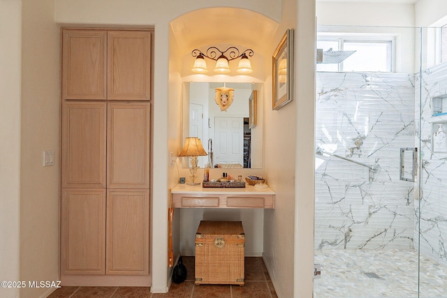 bathroom with tile patterned flooring and a shower with door