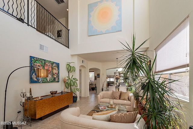 tiled living room with a high ceiling