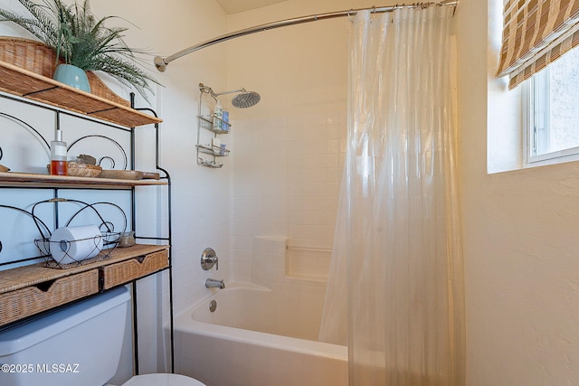 bathroom with shower / bath combo and toilet