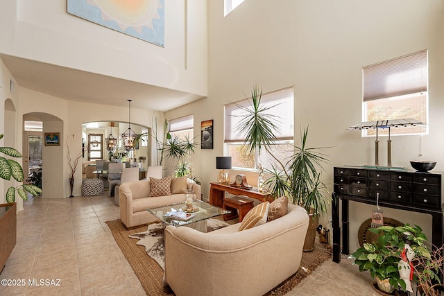 tiled living room featuring a high ceiling