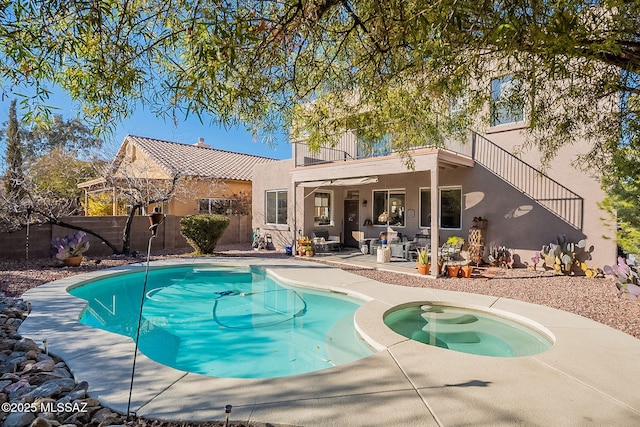 view of swimming pool featuring a patio and an in ground hot tub