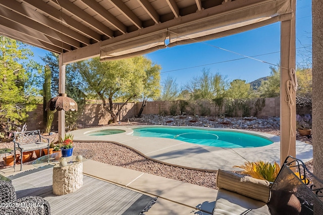 view of swimming pool with an in ground hot tub and a patio area