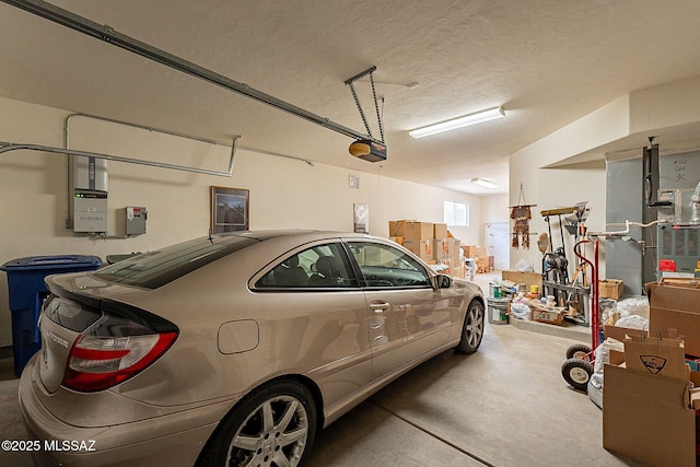 garage with a garage door opener and electric panel