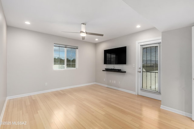 unfurnished living room featuring ceiling fan and light hardwood / wood-style floors