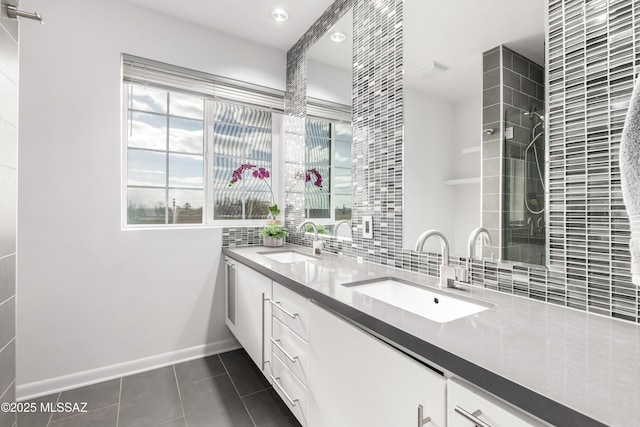 bathroom with tasteful backsplash, vanity, and tile patterned floors