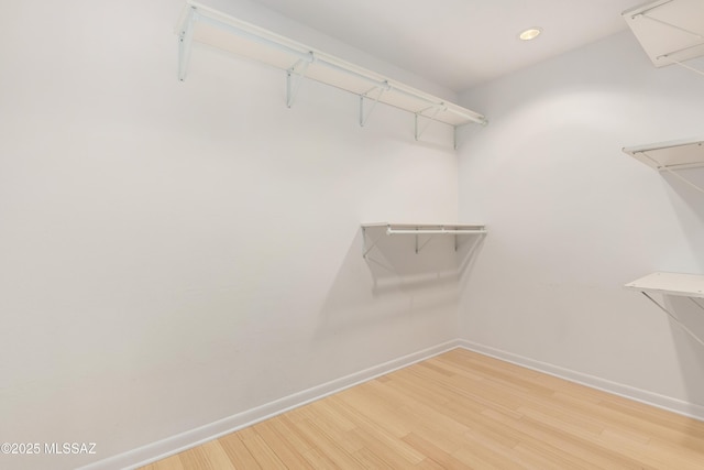 spacious closet featuring hardwood / wood-style flooring