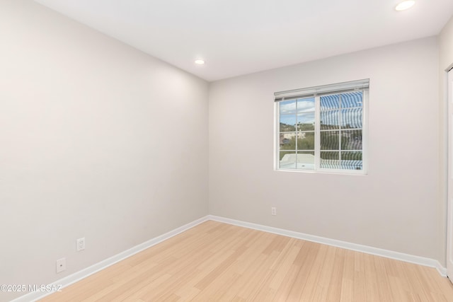 spare room featuring light hardwood / wood-style flooring