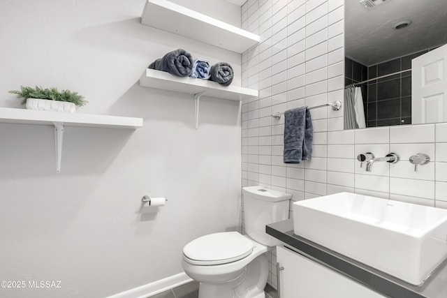 bathroom with tile walls, a shower with shower curtain, vanity, decorative backsplash, and toilet