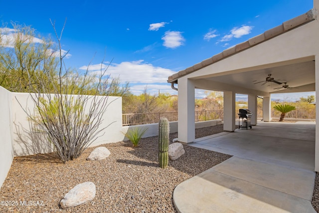 view of yard featuring a patio and ceiling fan