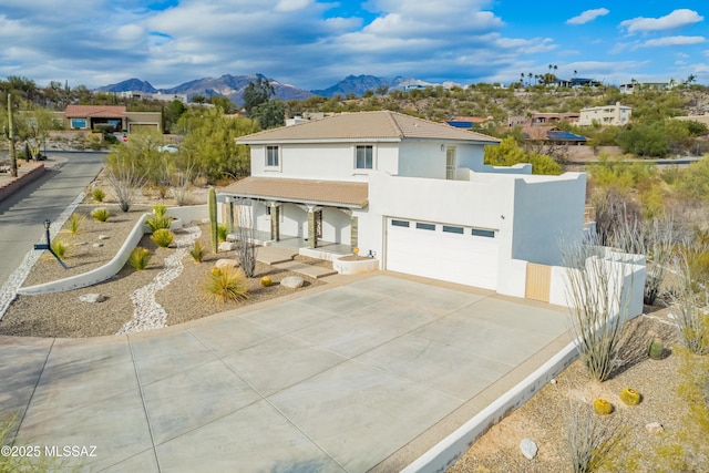 view of front of house with a garage and a mountain view