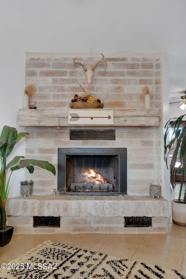 interior details with ceiling fan and a fireplace