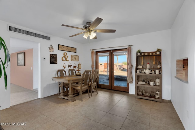 tiled dining room featuring french doors and ceiling fan