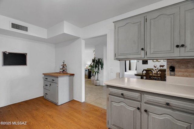 kitchen featuring gray cabinetry and light hardwood / wood-style floors