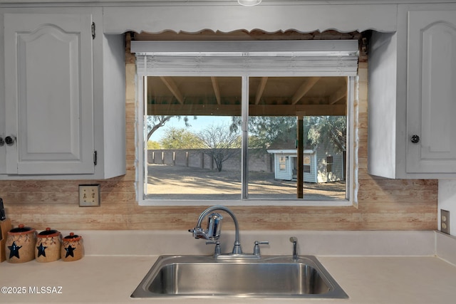 kitchen featuring white cabinetry and sink