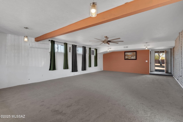 unfurnished room with beam ceiling, ceiling fan, and carpet