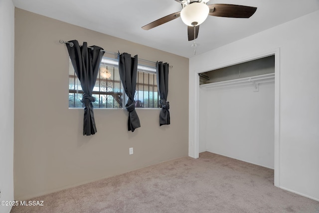 unfurnished bedroom with ceiling fan, light colored carpet, and a closet