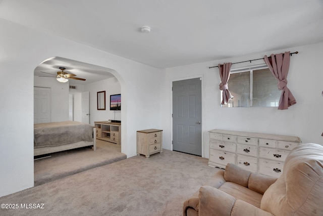 bedroom featuring light carpet and ceiling fan