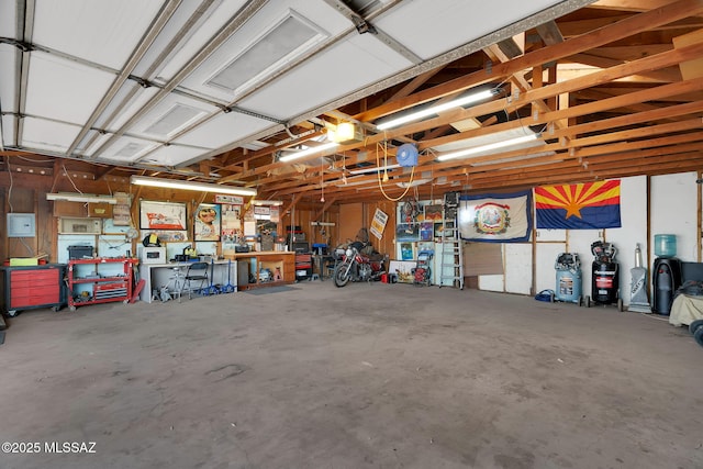 garage featuring a garage door opener and a workshop area