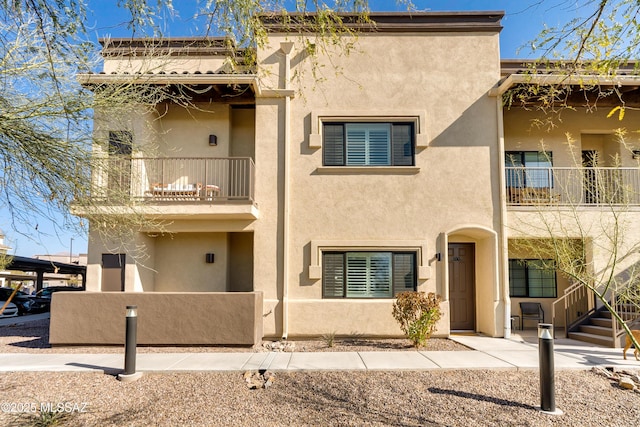 view of front of home featuring a balcony