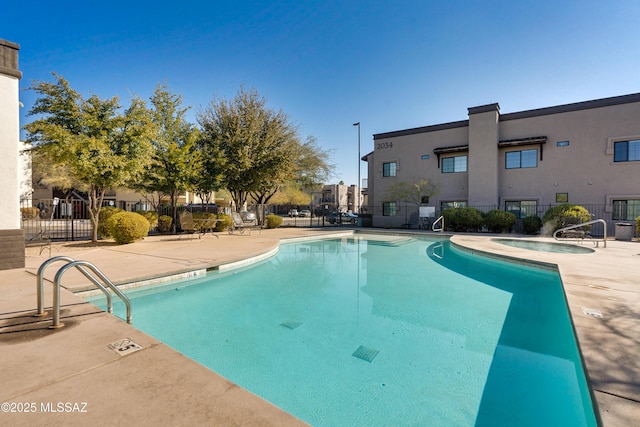 view of pool featuring a community hot tub and a patio area