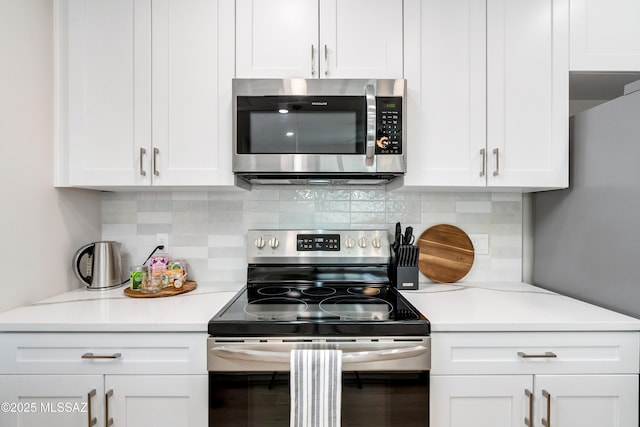 kitchen featuring white cabinetry and appliances with stainless steel finishes