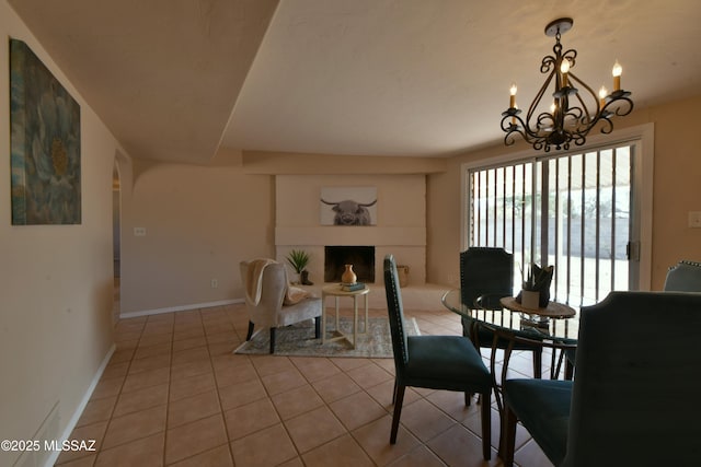 tiled dining room featuring an inviting chandelier