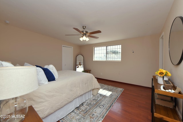 bedroom with ceiling fan and dark hardwood / wood-style flooring