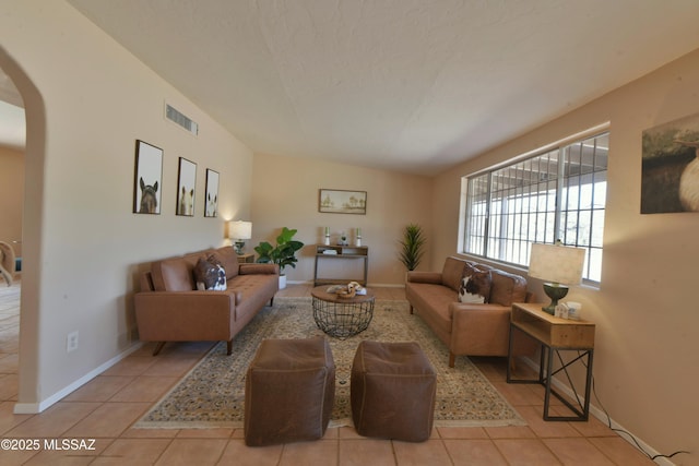 living room with light tile patterned floors and a textured ceiling