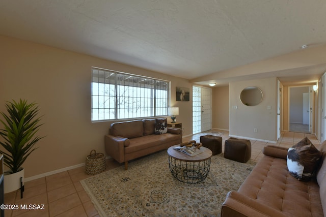 tiled living room featuring a textured ceiling