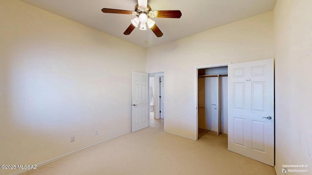 unfurnished bedroom with baseboards, a ceiling fan, a closet, and light colored carpet