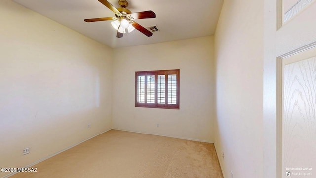 carpeted empty room featuring visible vents and ceiling fan