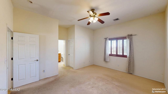 unfurnished bedroom featuring light colored carpet and visible vents
